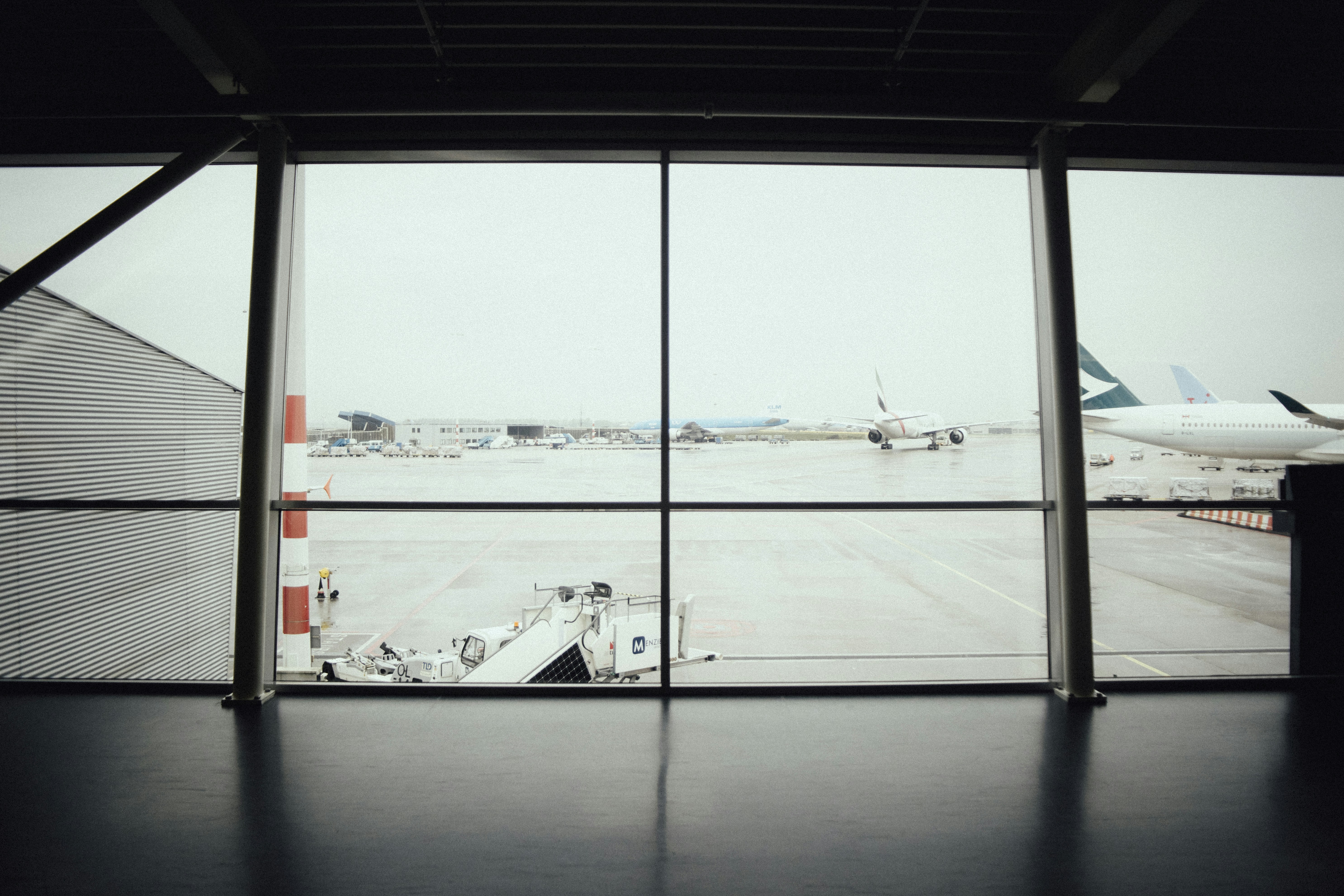 planes on runway through glass windows, waiting...waiting...waiting