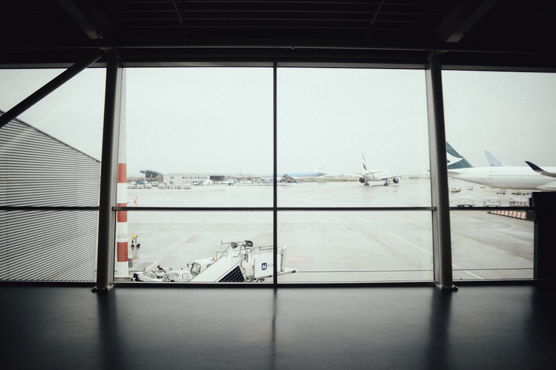 planes on runway through glass windows, waiting...waiting...waiting