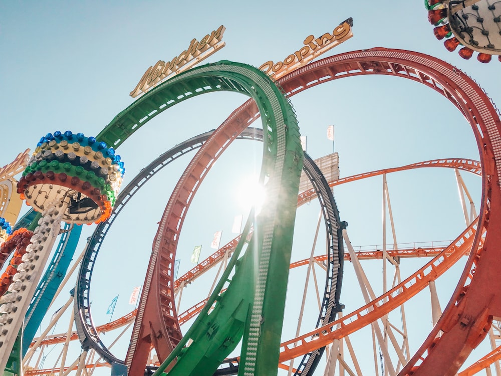 multicolored roller coaster during daytime