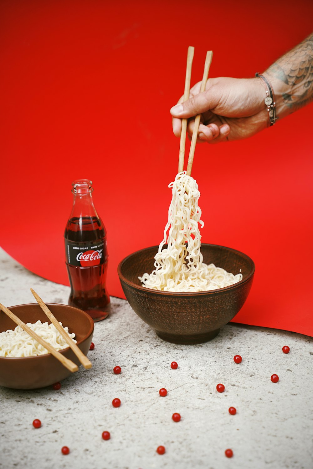 bowl of noodle near soda bottle