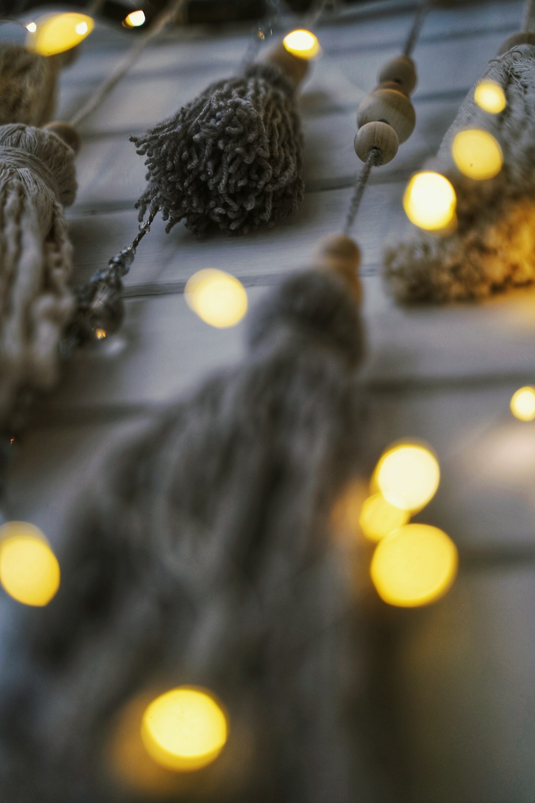 white tassels and string lights hanging on wall