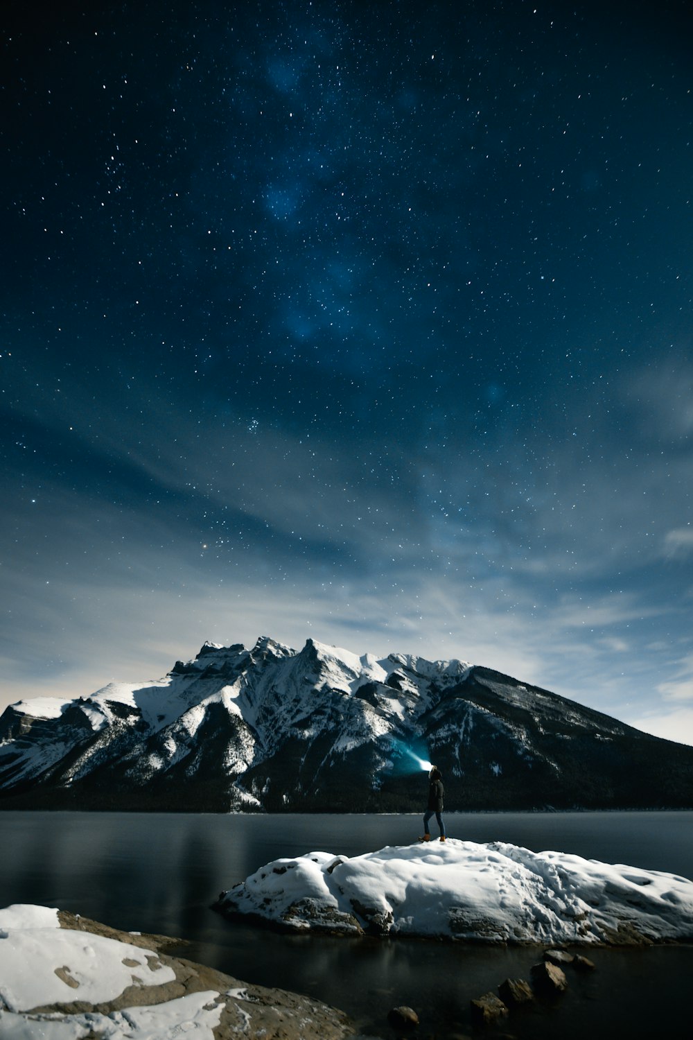 person standing on rock at night