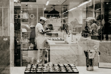 A chef preparing fresh bakery products in a professional kitchen.