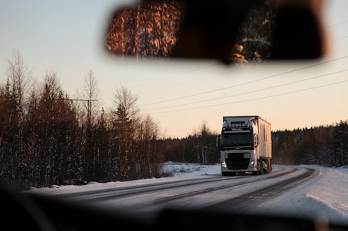 gray cargo truck on road during daytime