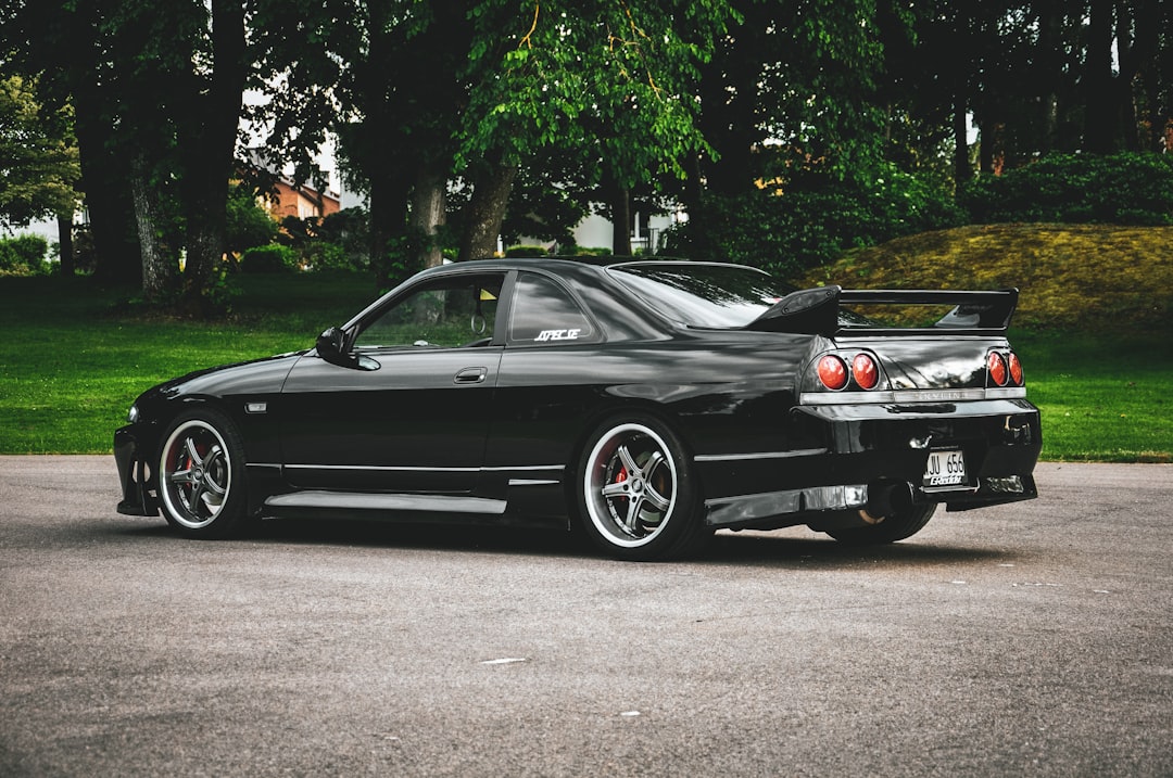 black Nissan Skyline GT-R coupe parking near road