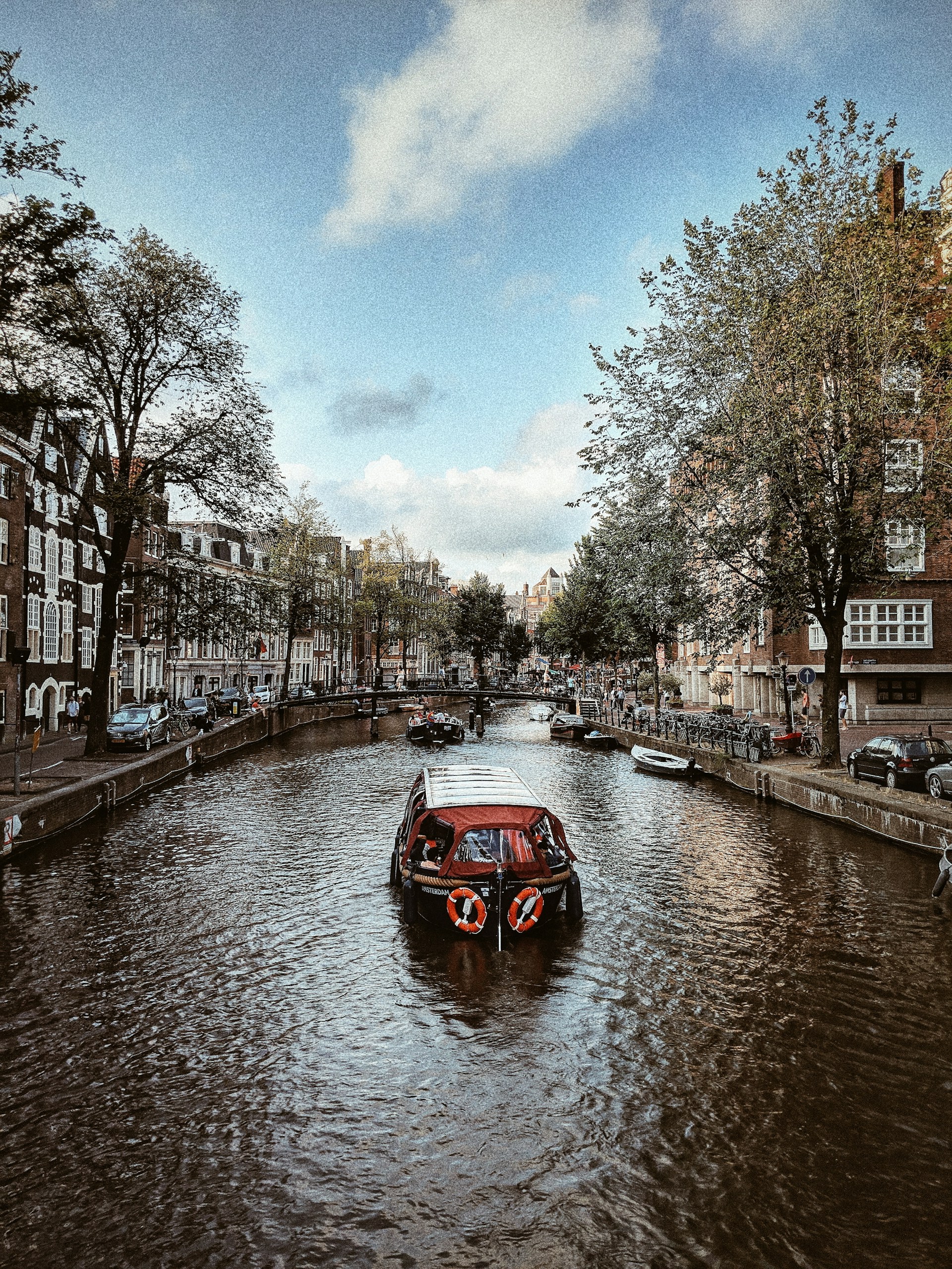 sailing boat near mini bridge during daytime