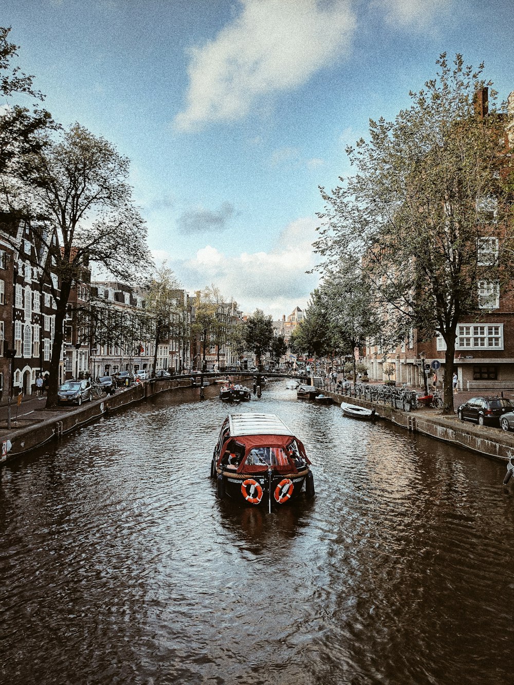 sailing boat near mini bridge during daytime