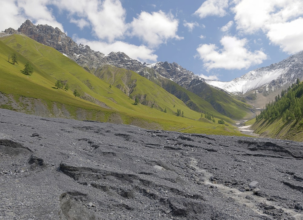 a view of a valley with mountains in the background