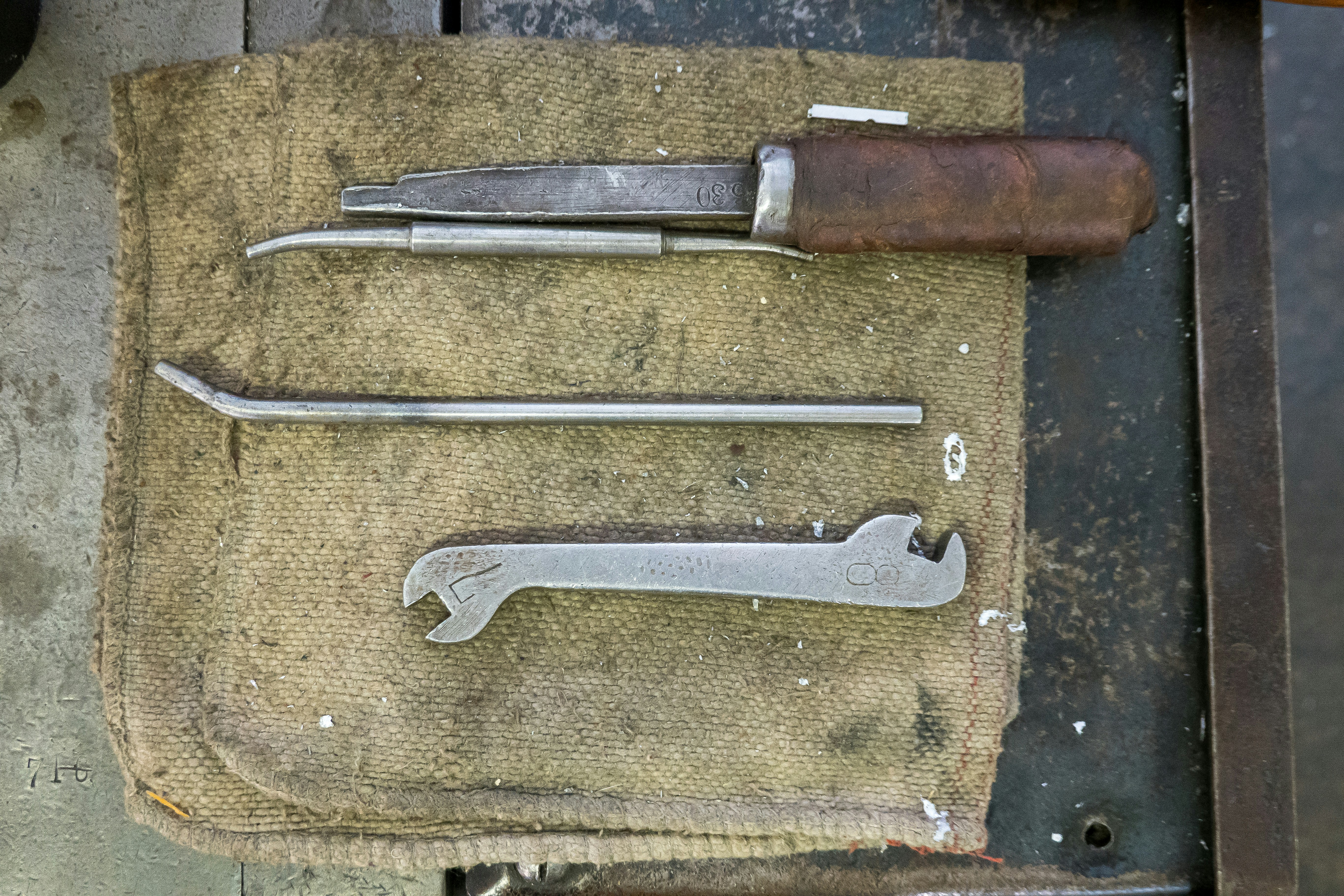 a pair of scissors and a knife on a piece of cloth