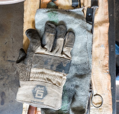 white and gray gloves on towel