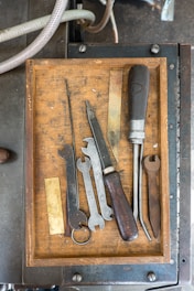 assorted-color mechanical tools on wooden tray