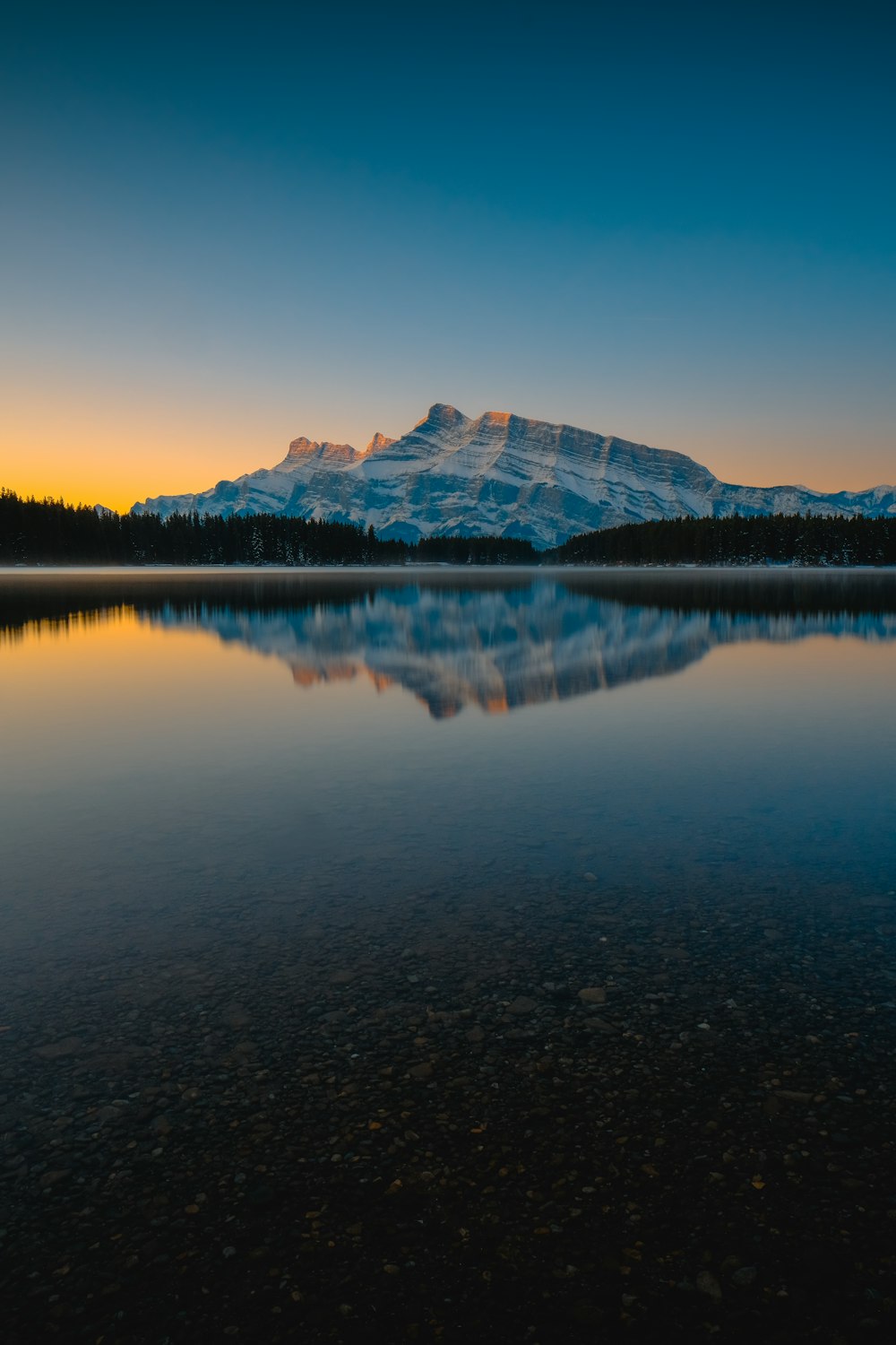 silhouette of mountain and lake