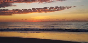 A sunrise over calm ocean waves symbolizing new beginnings and inspiration