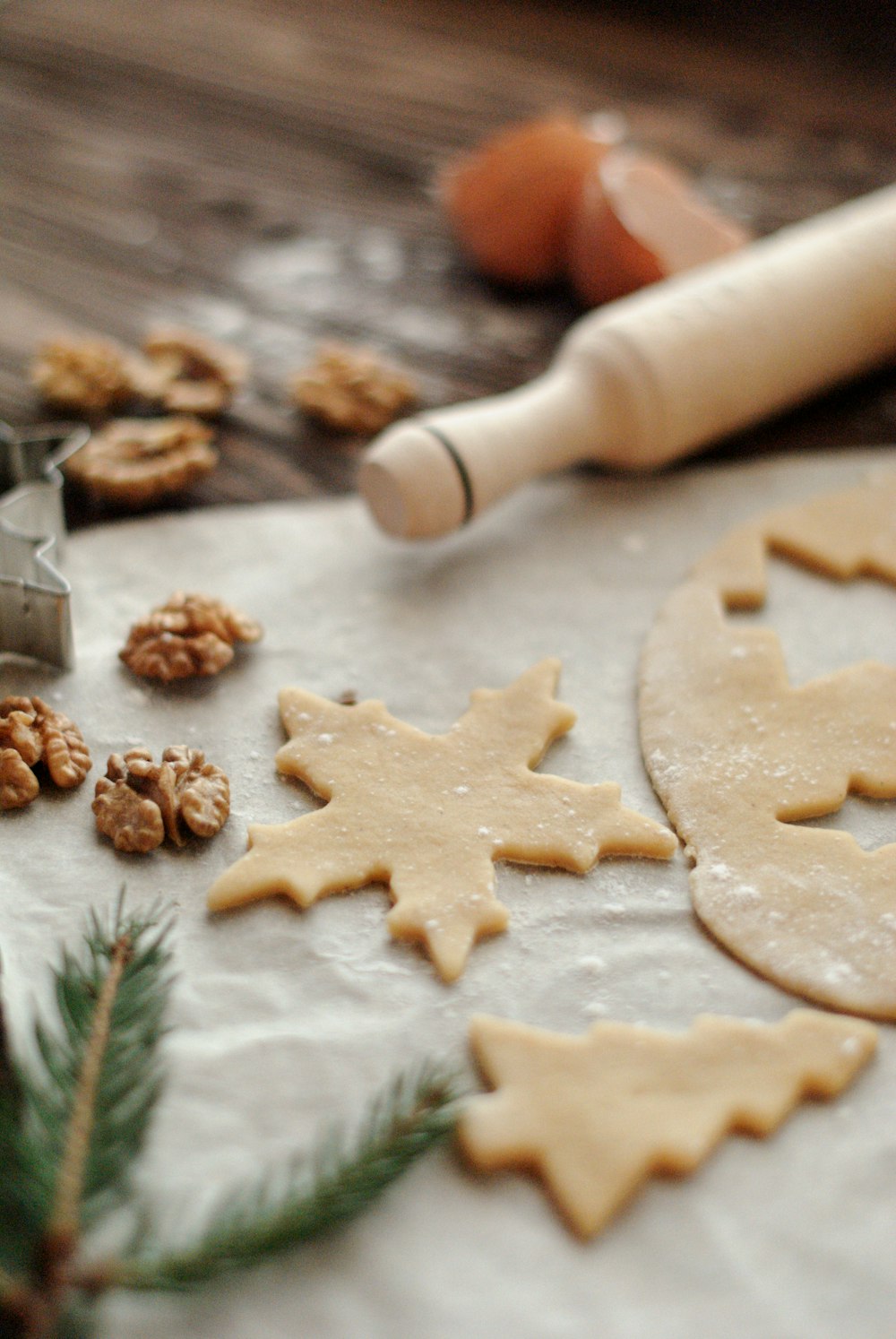 rolling pin beside cut cookie dough