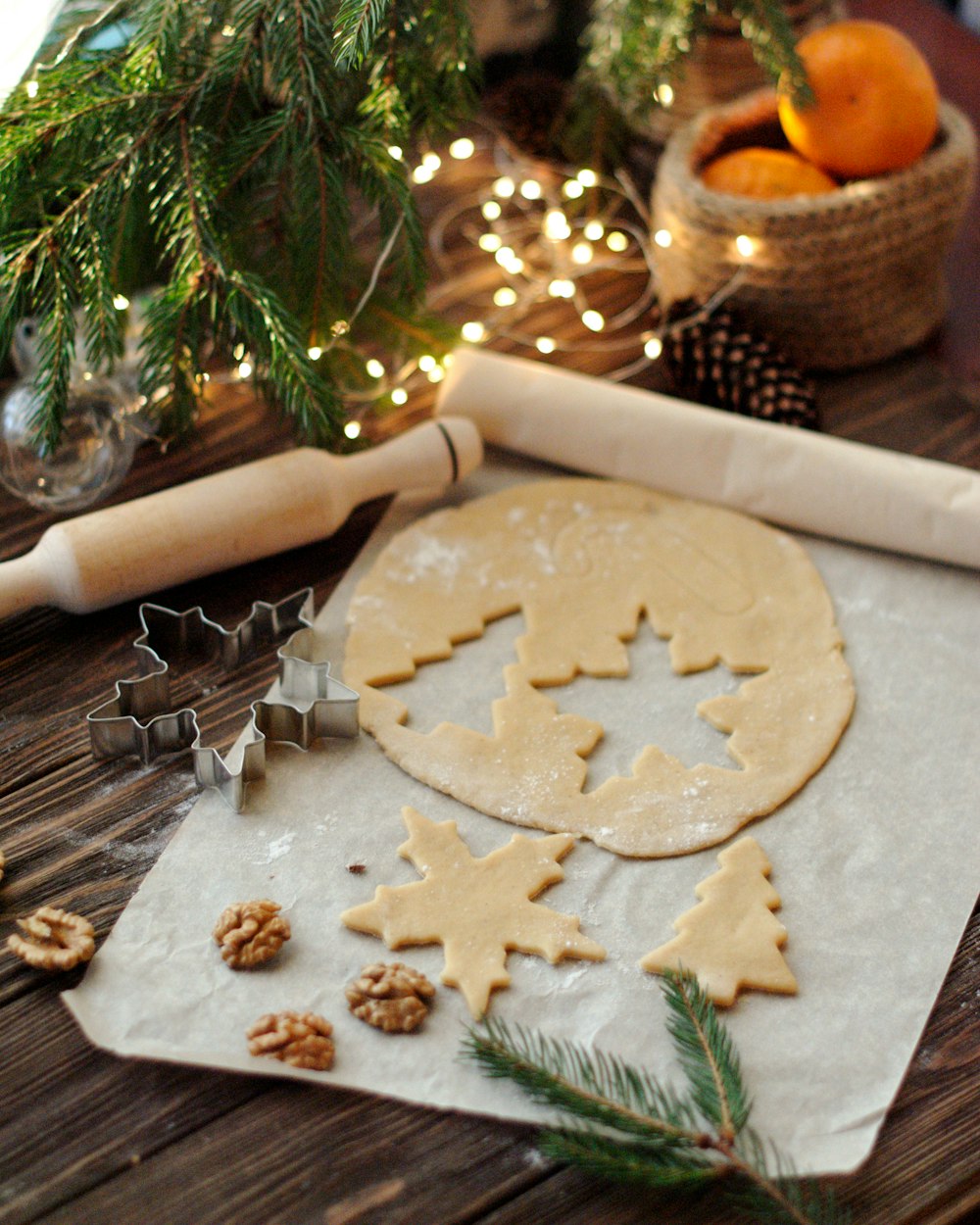cookie cutter and rolling pin beside string lights