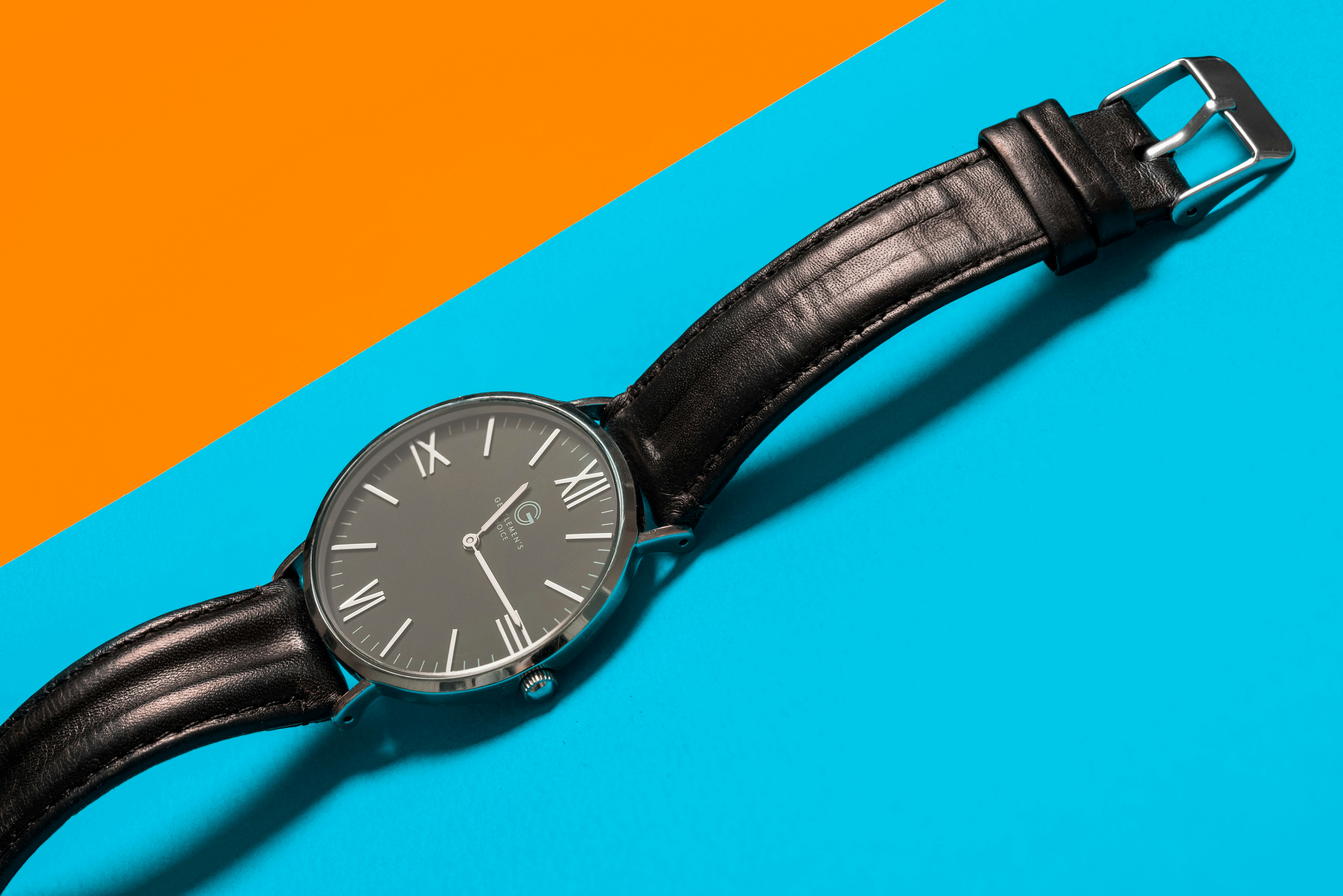 round black analog watch and black leather band