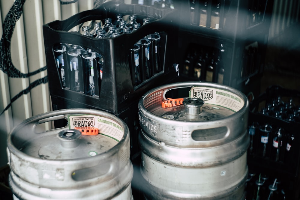 two gray stainless steel beer kegs