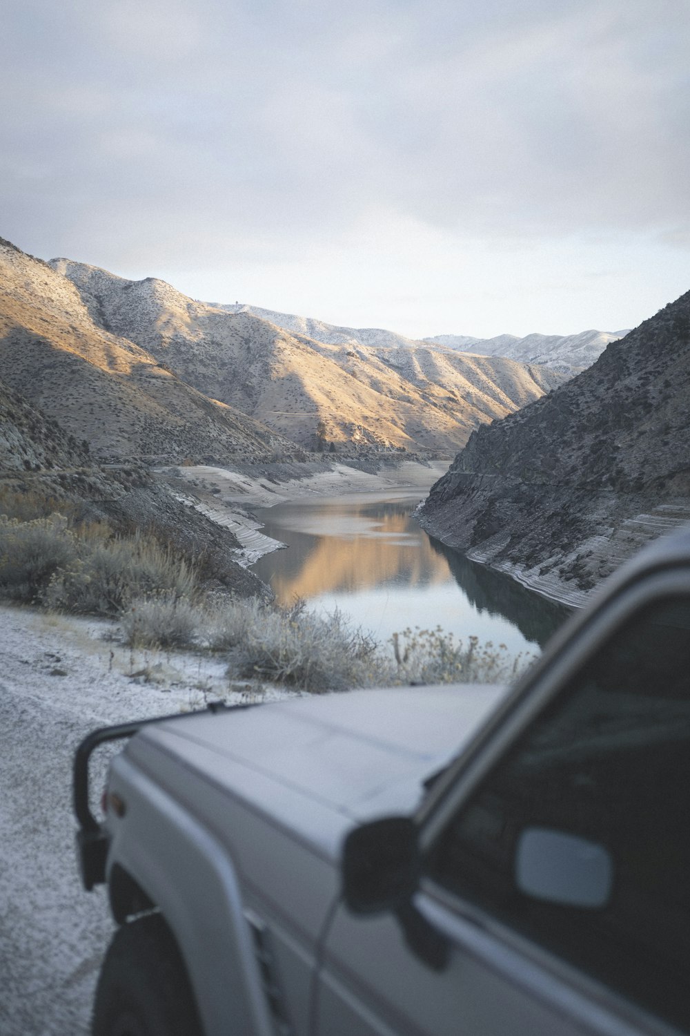 white vehicle parked on dirt road