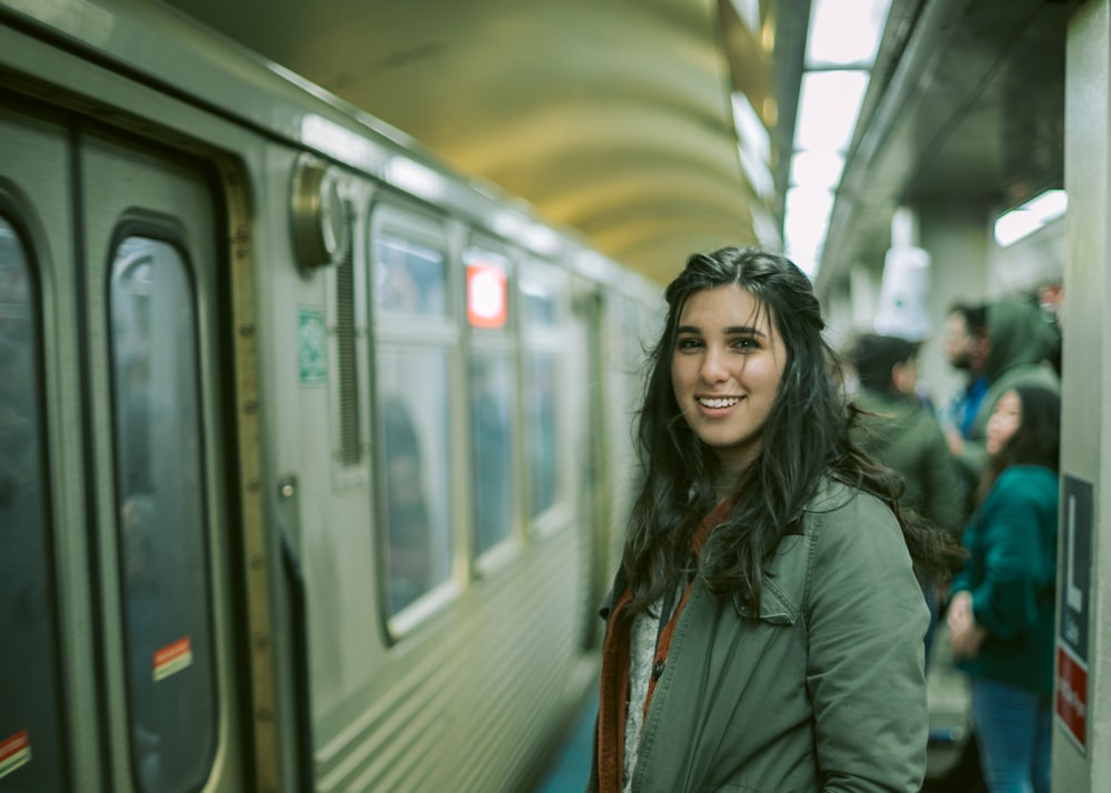 woman standing beside train