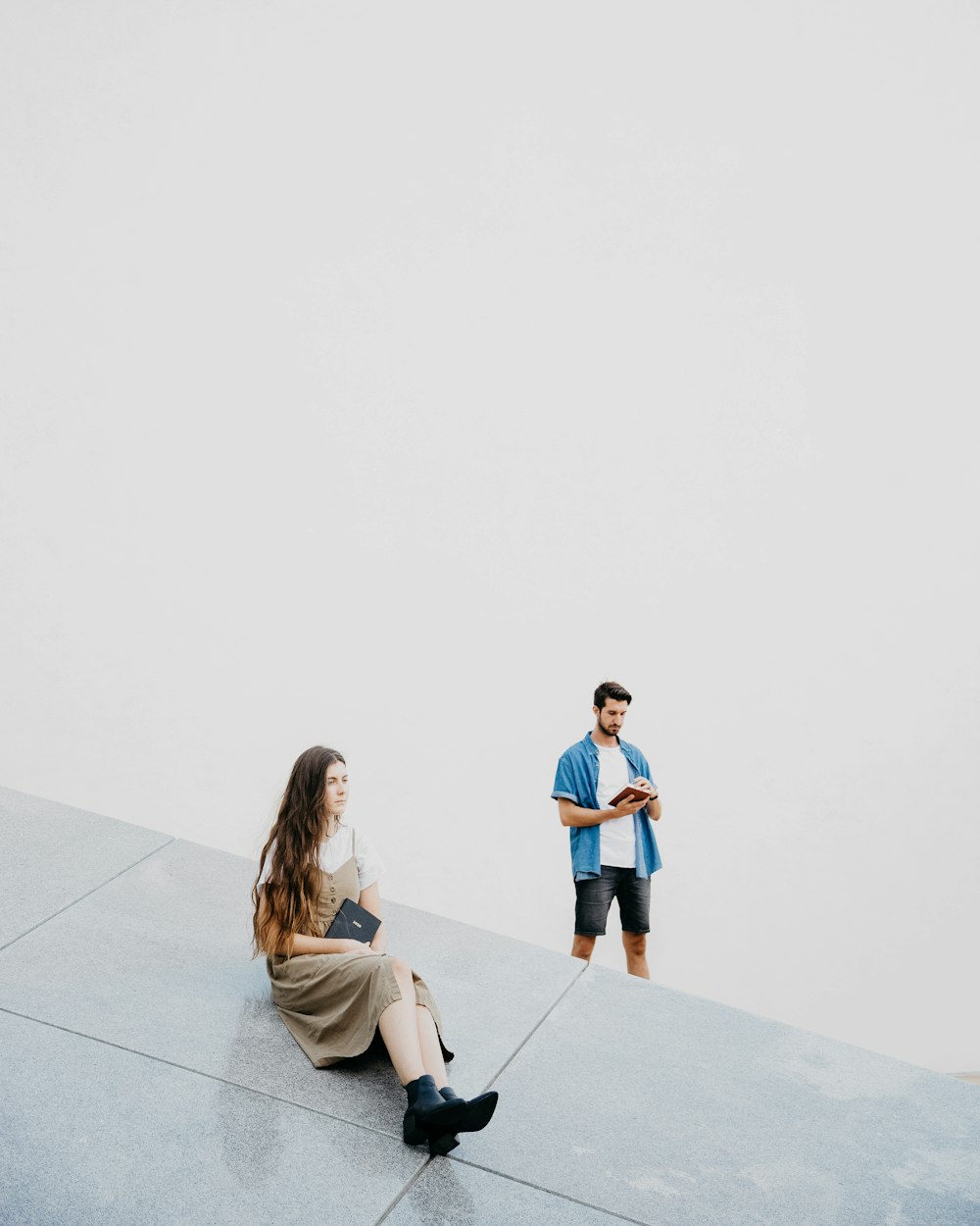 woman sitting on floor near man standing