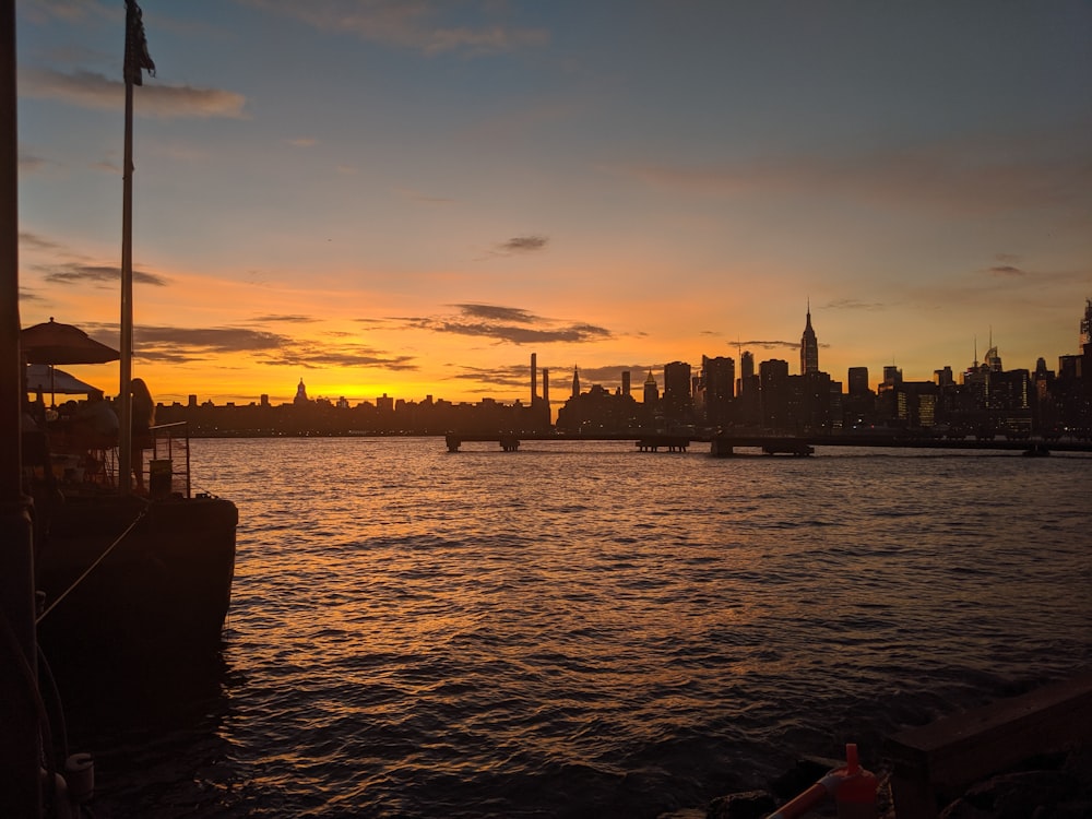 the sun is setting over the city skyline