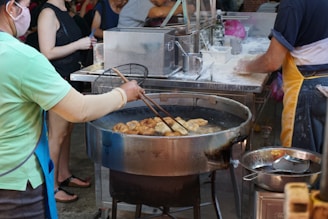 A vibrant kitchen scene featuring a shiny wok mid-sizzle with fresh vegetables and spices around.