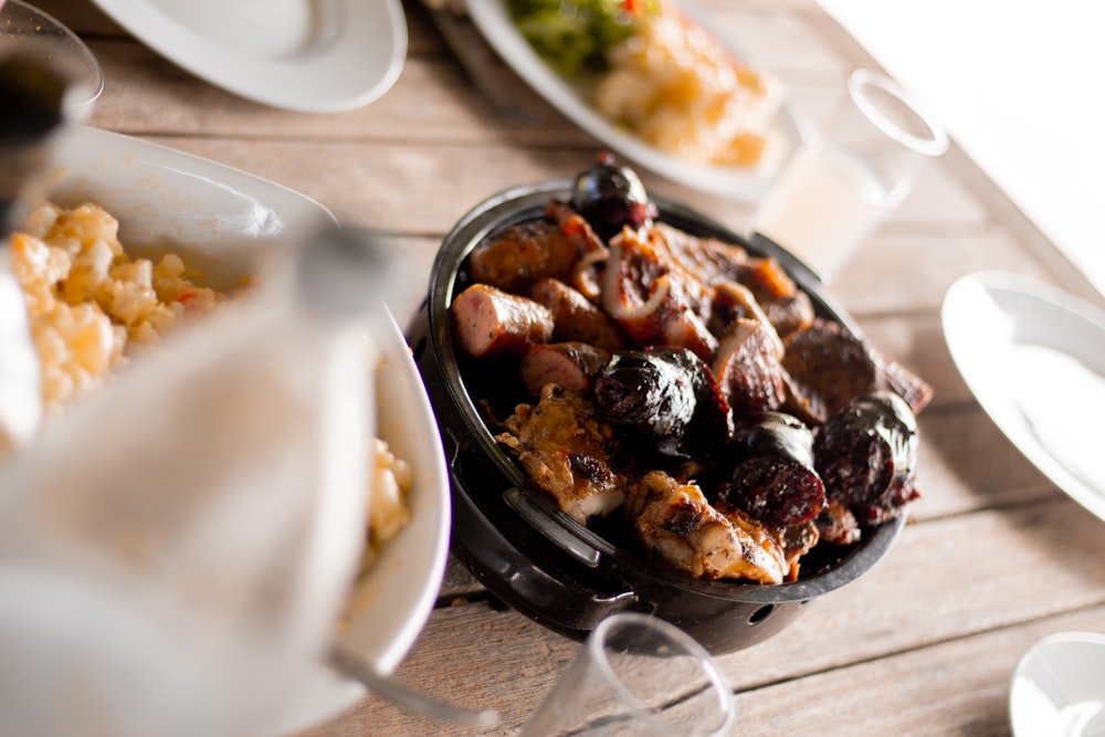 cooked food in round black casserole