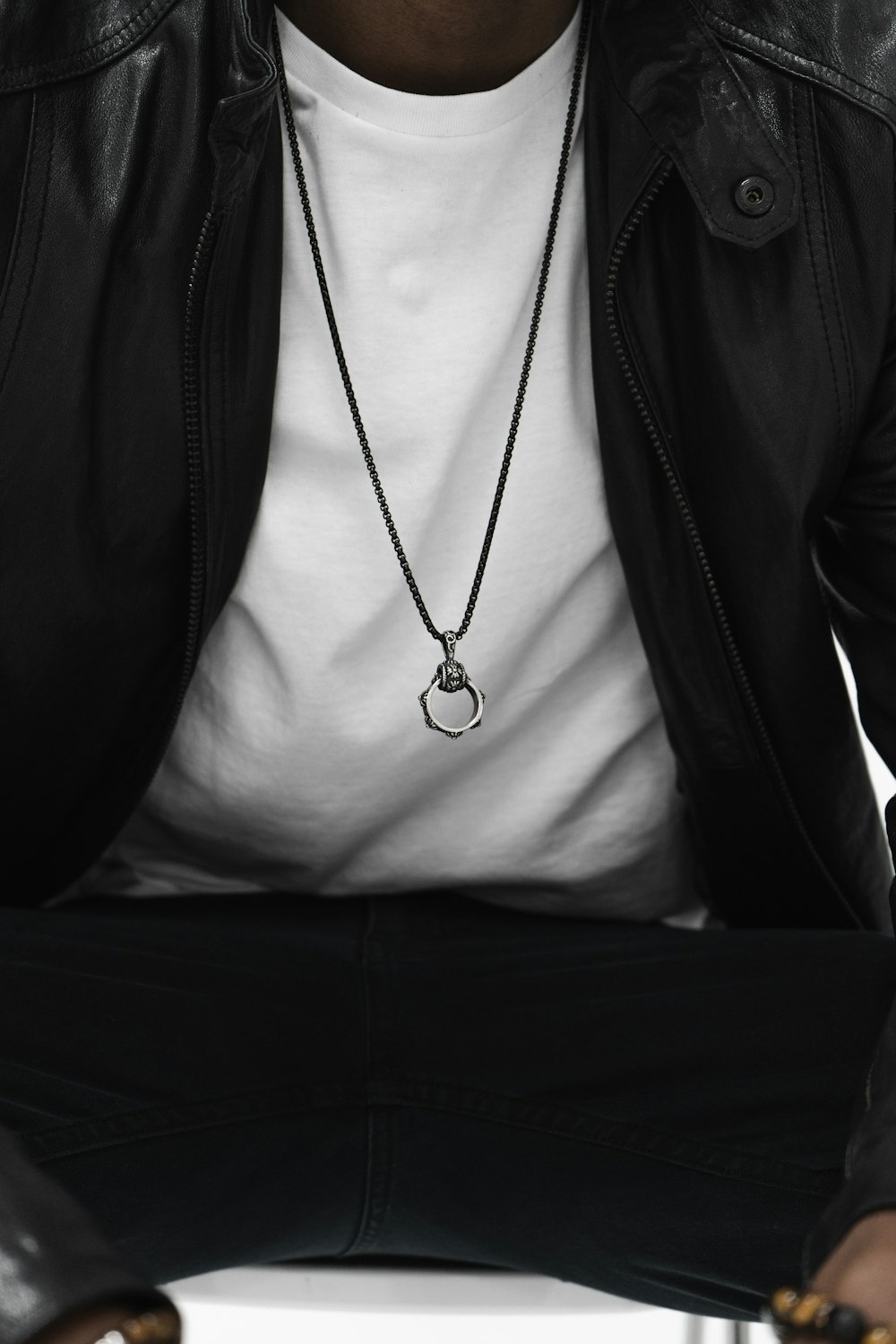 man wearing black necklace