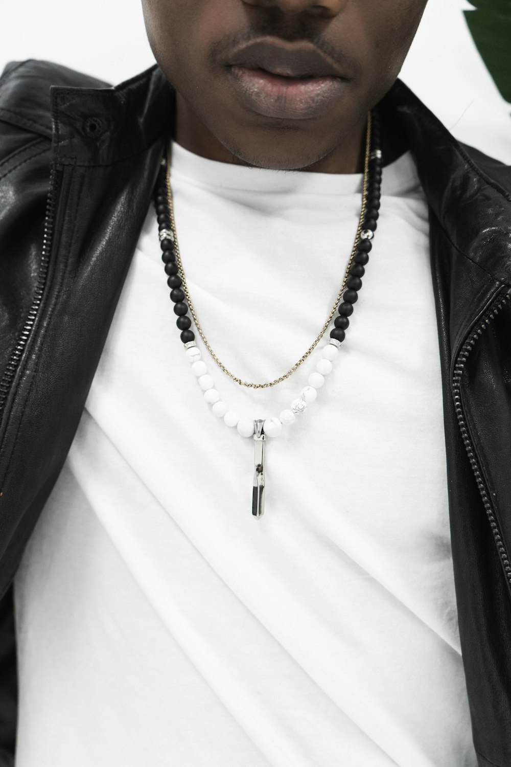 man wearing black and silver necklace