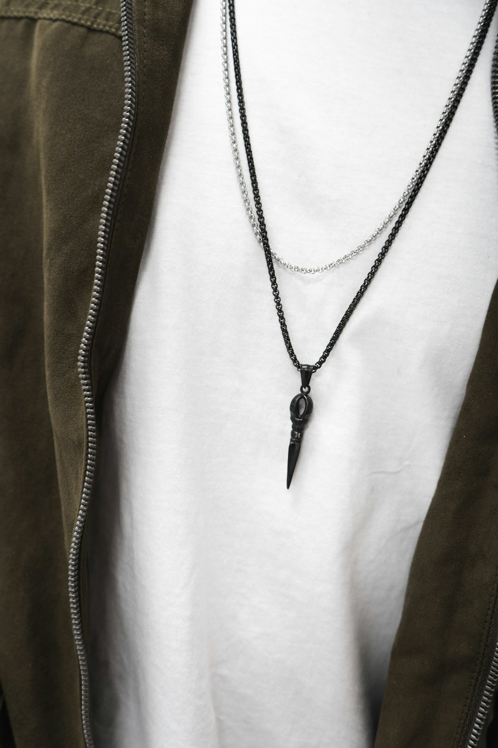 person wearing black necklace