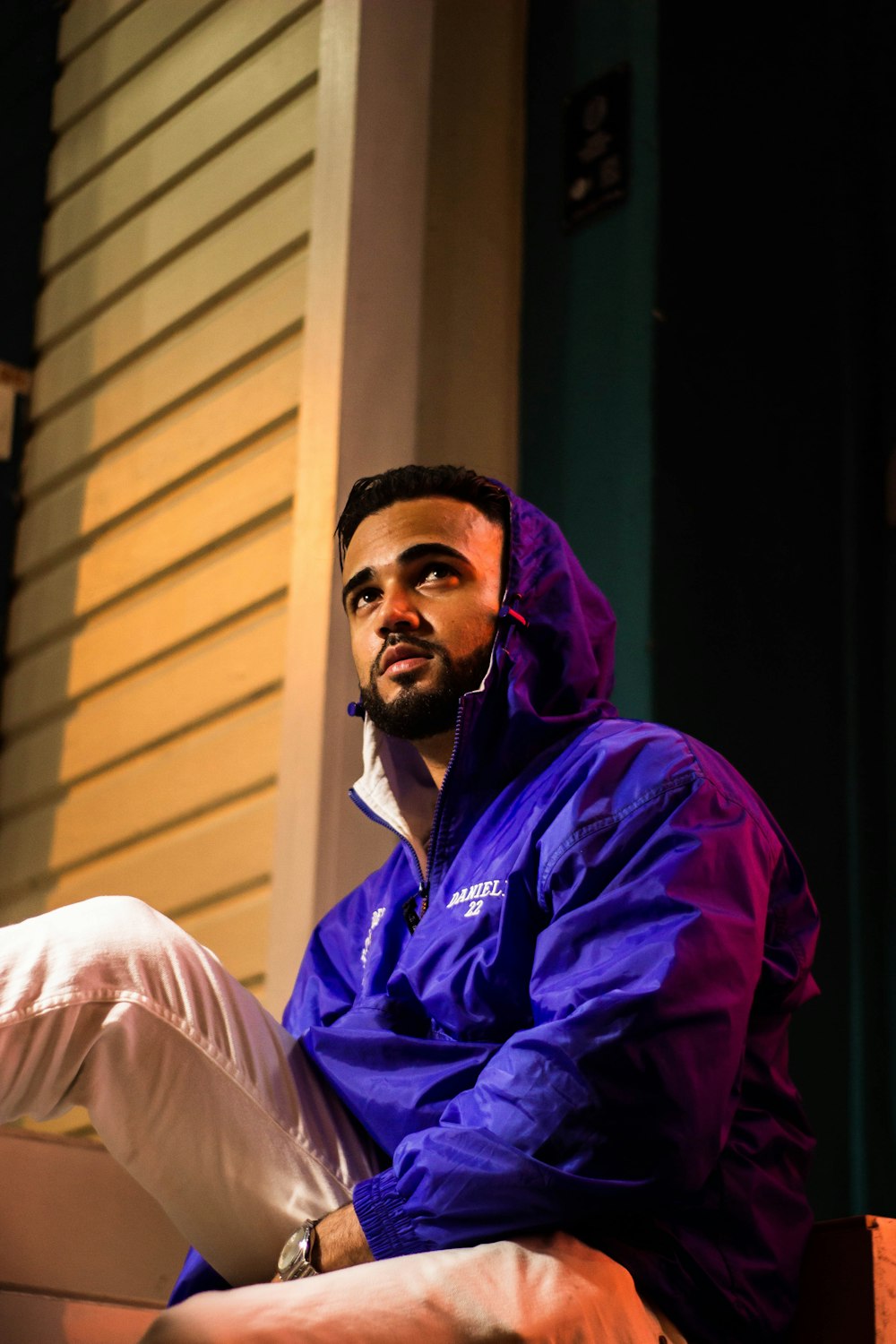 man wearing purple hooded jacket