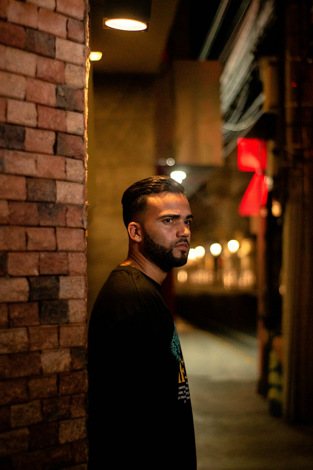 man wearing black jacket near the wall