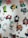 A collection of colorful, whimsical wall clocks and decorations featuring playful designs such as a cat, fish, crab, horse, teacups, and a red barn. Each piece is crafted with bold colors and imaginative shapes, creating a lively and artistic display.