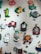 A collection of colorful, whimsical wall clocks and decorations featuring playful designs such as a cat, fish, crab, horse, teacups, and a red barn. Each piece is crafted with bold colors and imaginative shapes, creating a lively and artistic display.