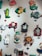 A collection of colorful, whimsical wall clocks and decorations featuring playful designs such as a cat, fish, crab, horse, teacups, and a red barn. Each piece is crafted with bold colors and imaginative shapes, creating a lively and artistic display.