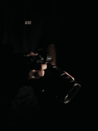 person holding black DSLR camera