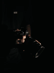 person holding black DSLR camera