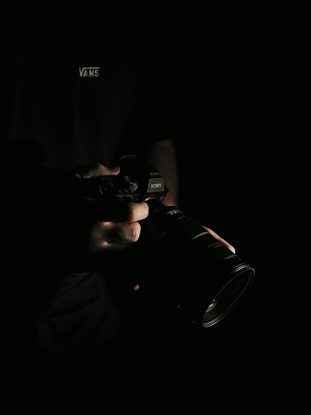 person holding black DSLR camera