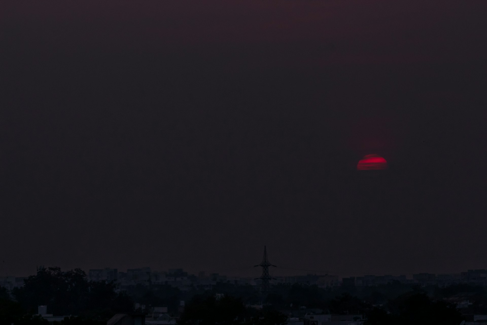 the sun is setting over the city skyline