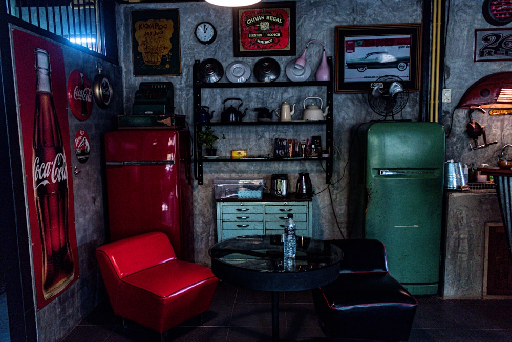 two red and green refrigerator and chairs