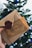 A hand is holding a ticket and an envelope with a wax seal in front of a blurred Christmas tree. The ticket reads 'Hogwarts Express' and 'Platform 9 3/4', evoking a magical theme.