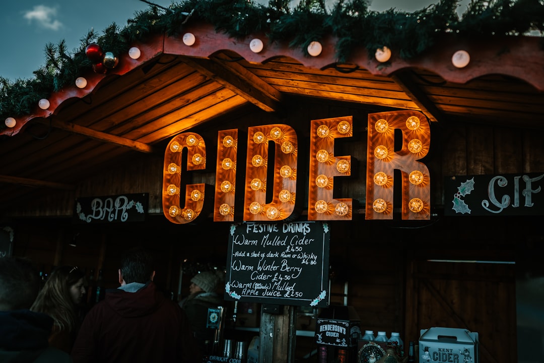 brown wooden house, Cider hut at Leeds Castle Christmas Market. I absolutely LOVE the colour these bulbs were giving out