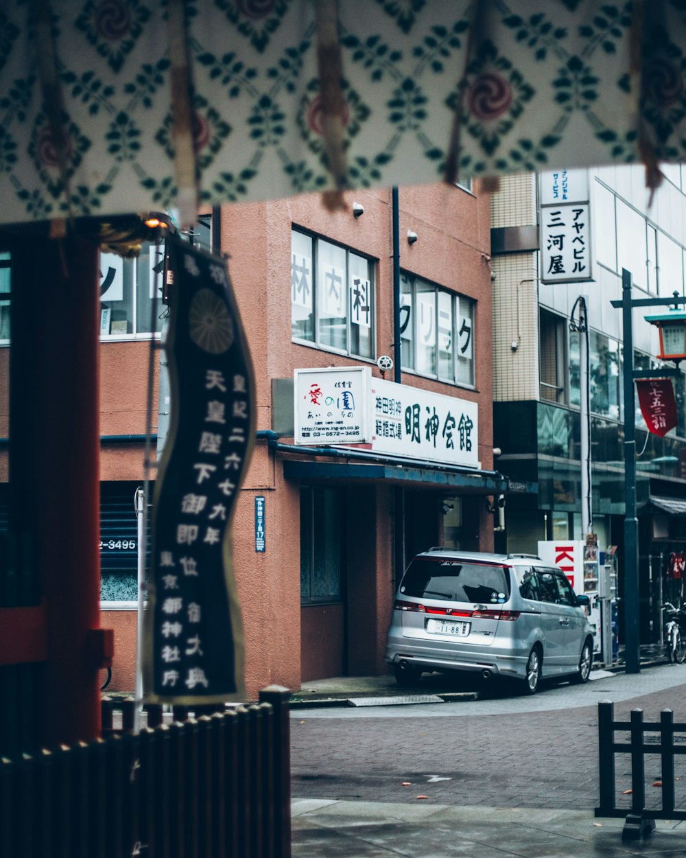 view photography of silver van parked beside store building