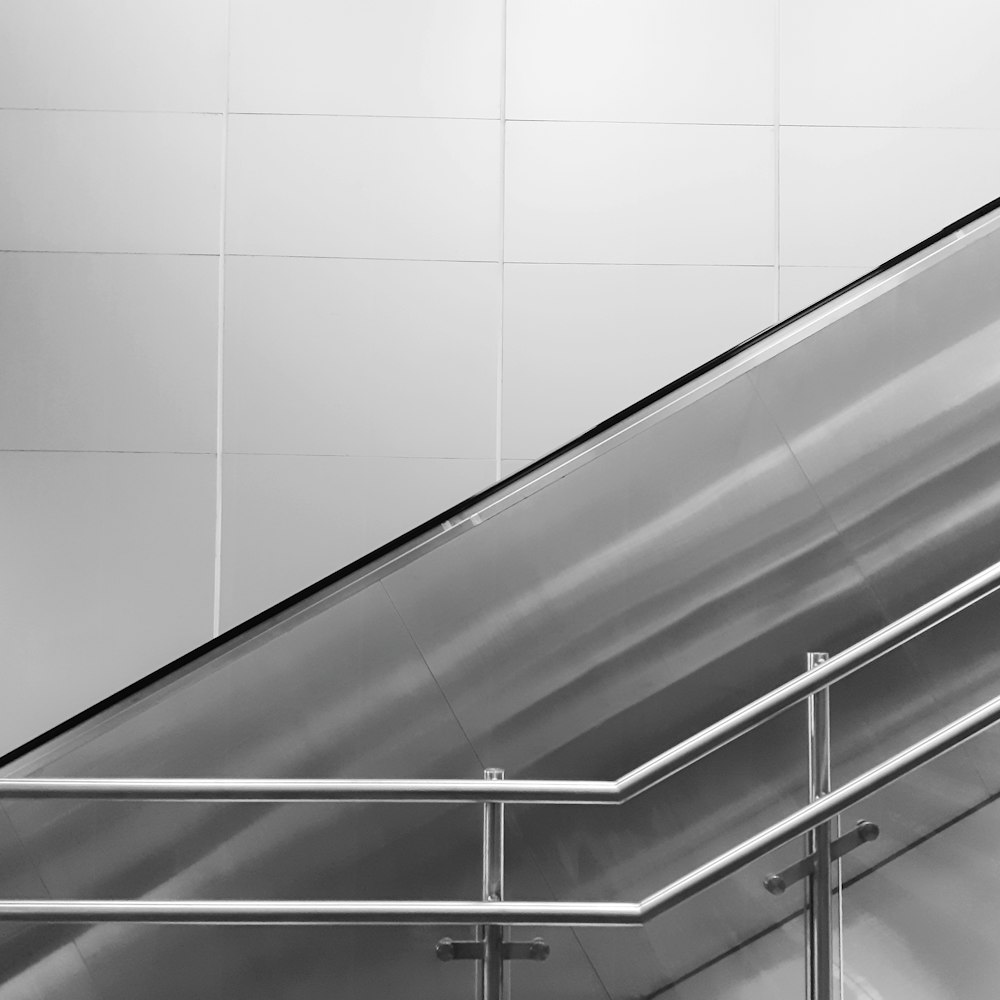 a black and white photo of an escalator