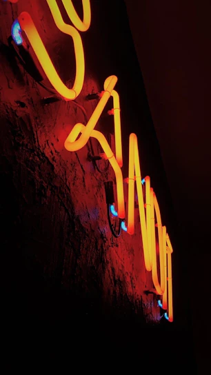 A sleek ambient LED light casting vibrant neon blue glows on a dark modern room wall.