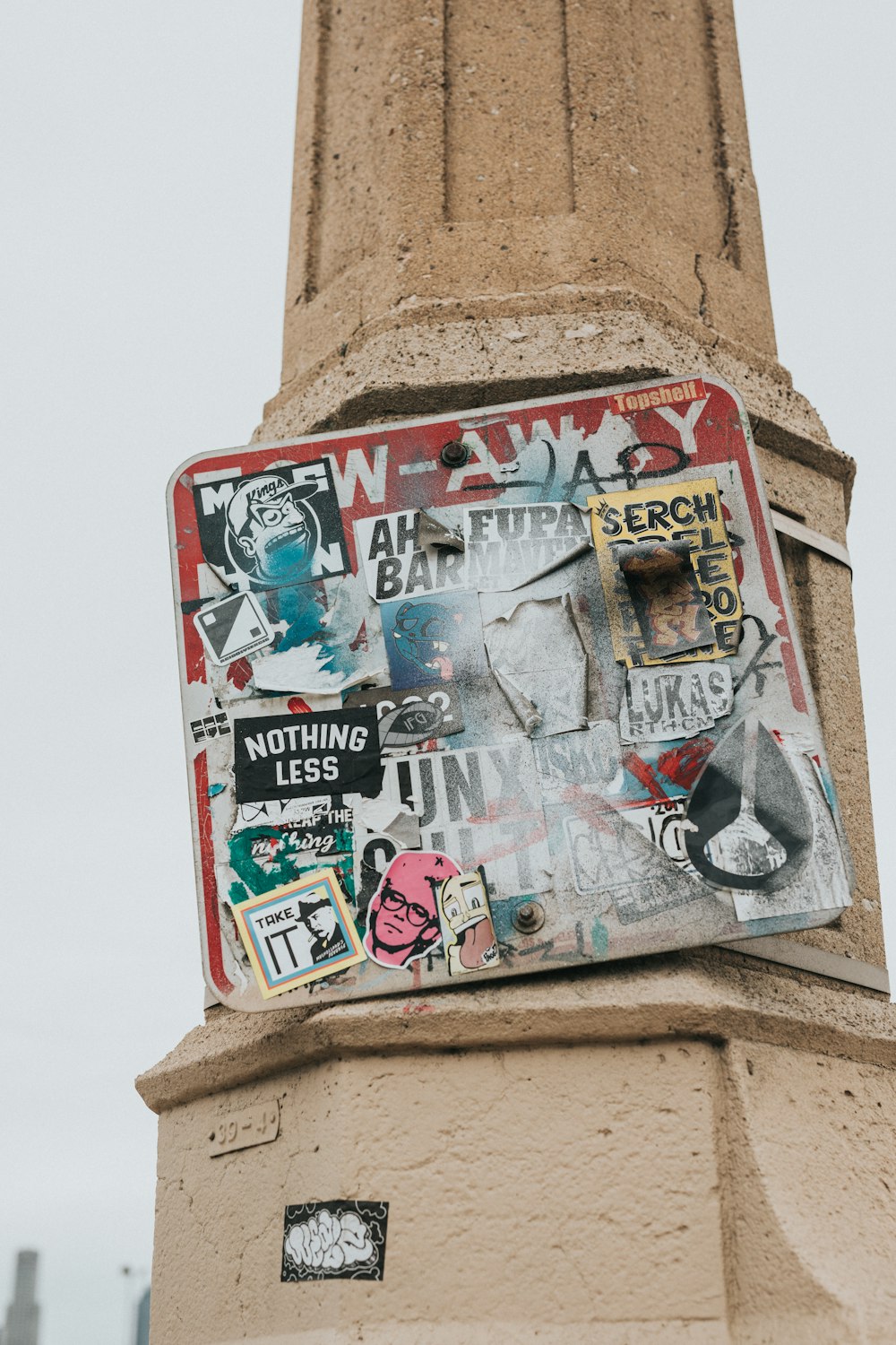 a pole with a bunch of stickers on it