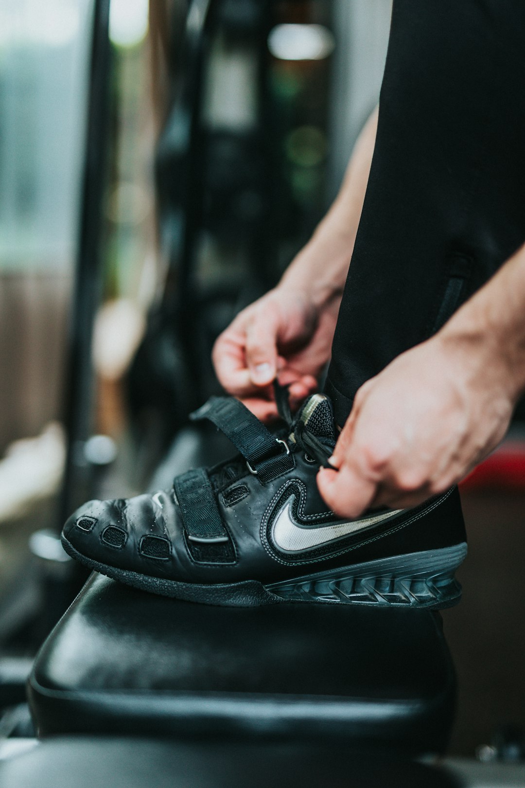 selective focus photography of person tying shoes