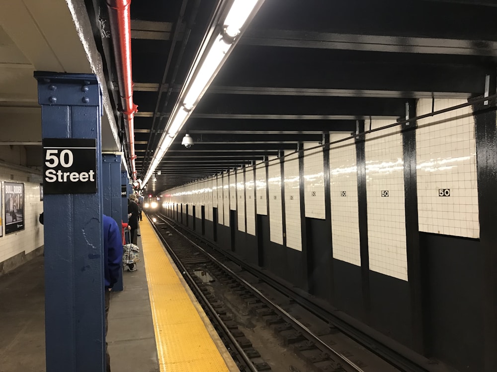 a subway station with people waiting for the train