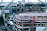 A sleek modern urban construction site in Guadalajara with cranes and workers.
