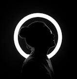 woman standing beside halo light